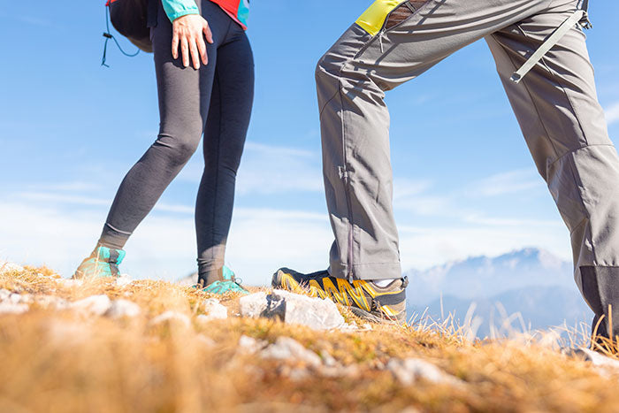 Moosehill HikerFlex series durable hiking pants vs. lightweight leggings for men and women on a forest trail